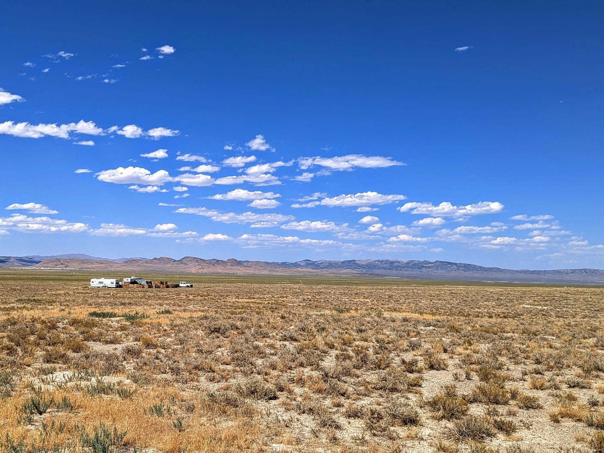 Open acreage and distant ridgeline under a clear sky